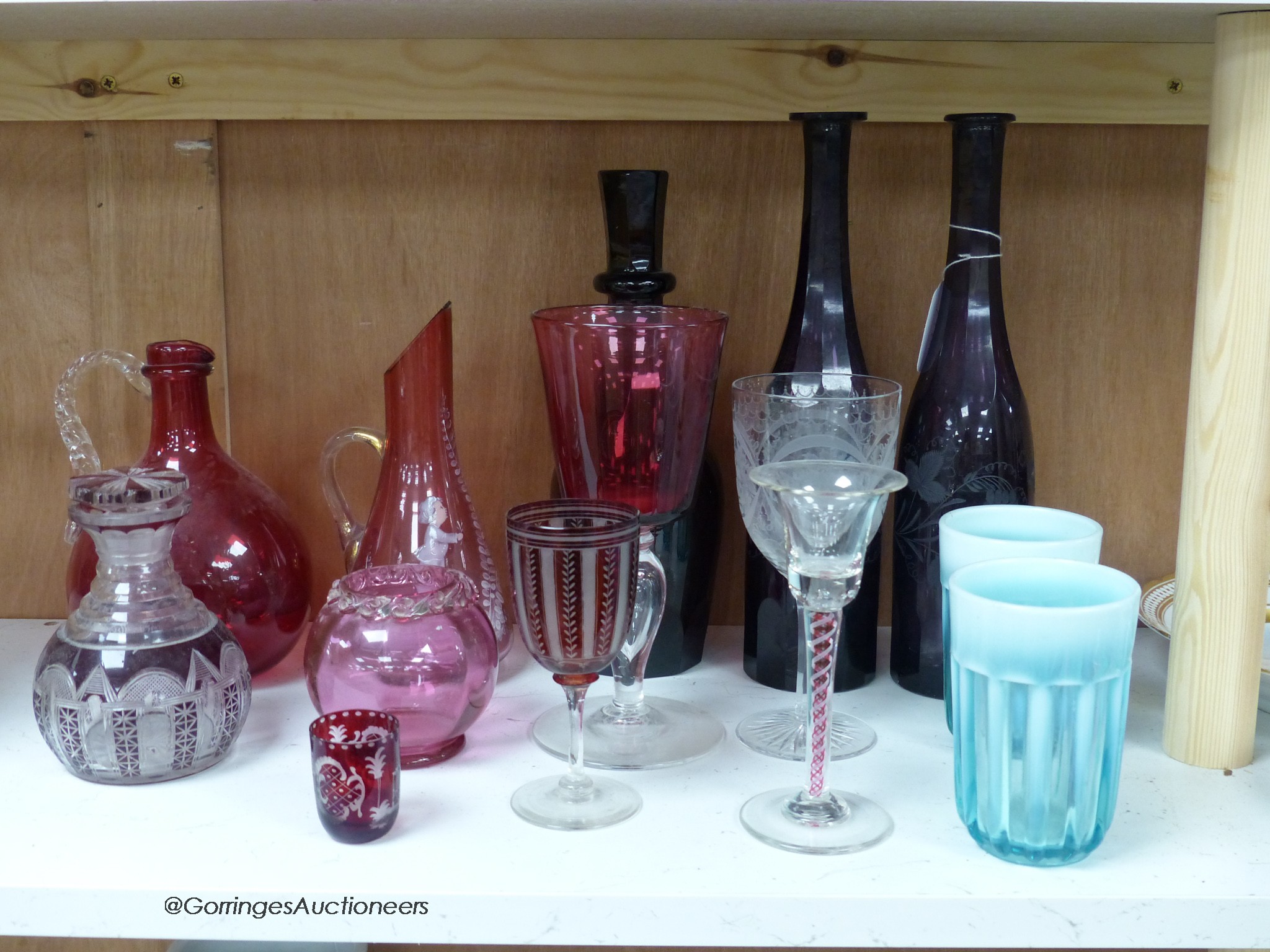 A pair of amethyst glass decanters, cranberry glass and mixed 19th and 20th century coloured glassware